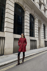 a lady in a red tweed coat